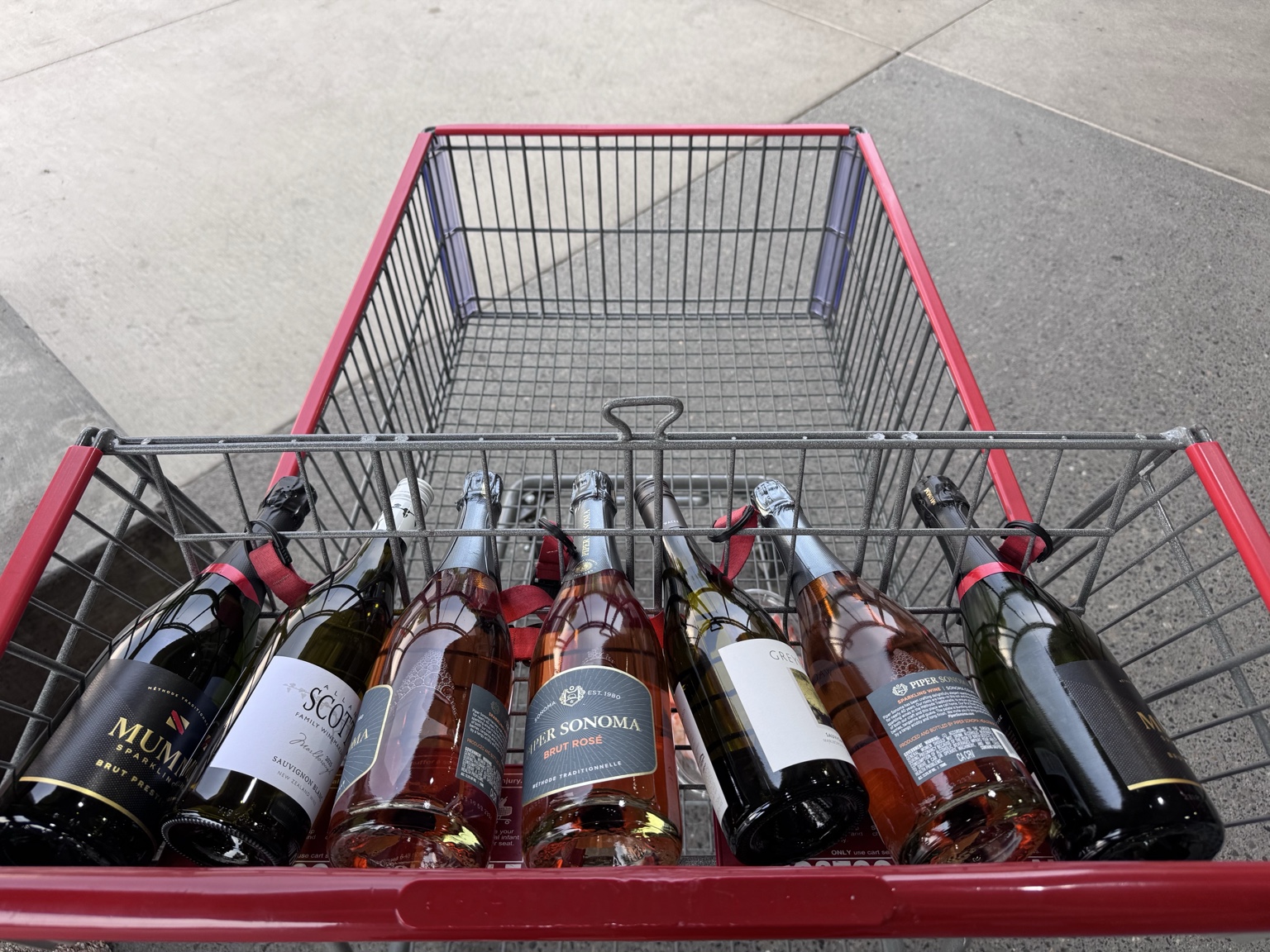 A Costco cart filled with sparkling wine