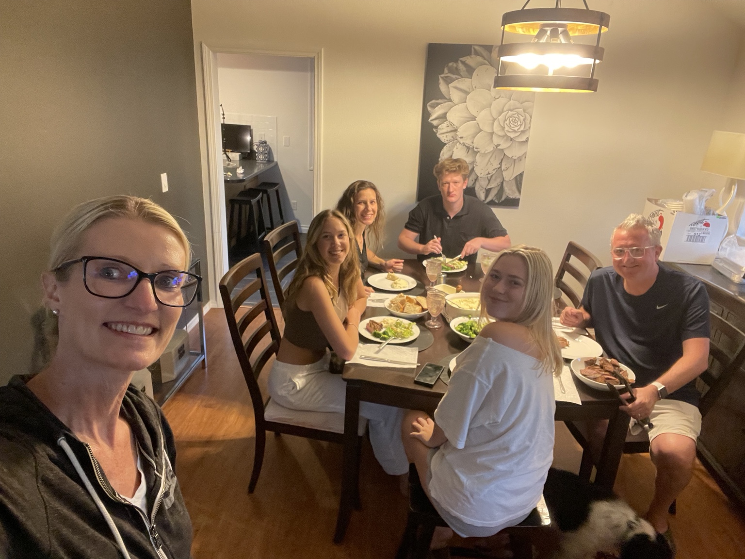 Kami with family and friends gathered around the dinner table